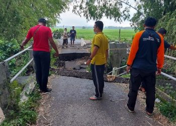 Penampakan jembatan tua yang roboh akibat hujan deras di Nganjuk. Foto: Bacaini/ Asep Bahar