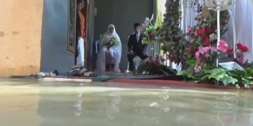 Acara resepsi pernikahan warga Jombang ditengan genangan air banjir. Foto: Bacaini/Syailendra