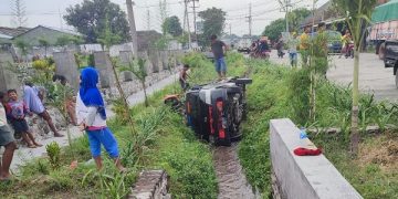 Mobil pikap yang mengalami pecah ban hingga masuk ke dalam parit. Foto: Bacaini/AK.Jatmiko