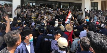 Aksi saling dorong antara aparat kepolisian dengan mahasiswa pendemo di Gedung DPRD Bangkalan. Foto: Bacaini/Rusdi