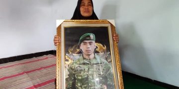 Zuliana, ibu Prada Beryl menunjukkan foto anaknya yang gugur saat tugas di Papua. Foto: Bacaini/Novira