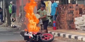Warga di sekitar lokasi saat berusaha memadamkan api. Foto: Bacaini/AK.Jatmiko