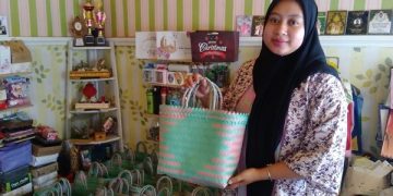 Umi Safitri, istri dari Fery menunjukkan tas anyaman plastik KnD Project. Foto: Bacaini/Fio