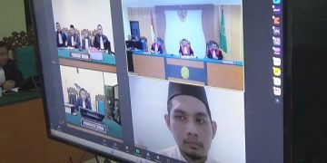 Sidang pembacaan dakwaan terhadap AP Hasanuddin secara online. Foto: Bacaini/Syailendra