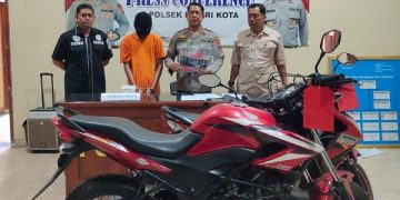 Fani memakai baju tahanan bersama sepeda motor hasil curian yang diamankan polisi. Foto: Bacaini/AK.Jatmiko