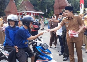 Wabub Syah ikut membagikan Bendera Merah Putih bagi pengguna jalan. Foto: Ist