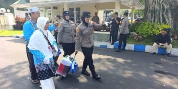 Ilustrasi calon jemaah haji Indonesia mengenakan pakaian ihram dan seragam haji saat bersiap berangkat menuju Tanah Suci di bandara